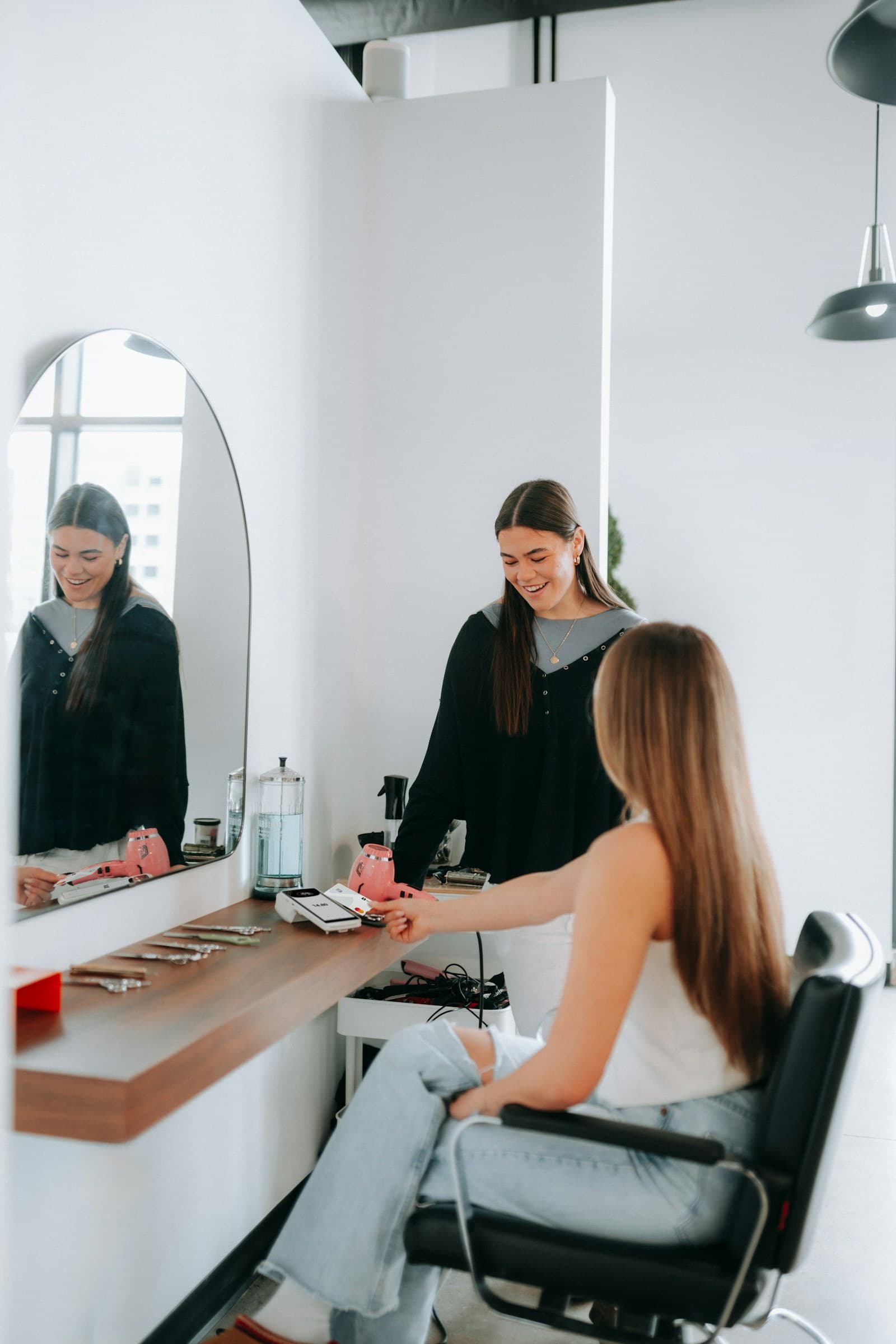 Stylist caring for a client in a bright salon